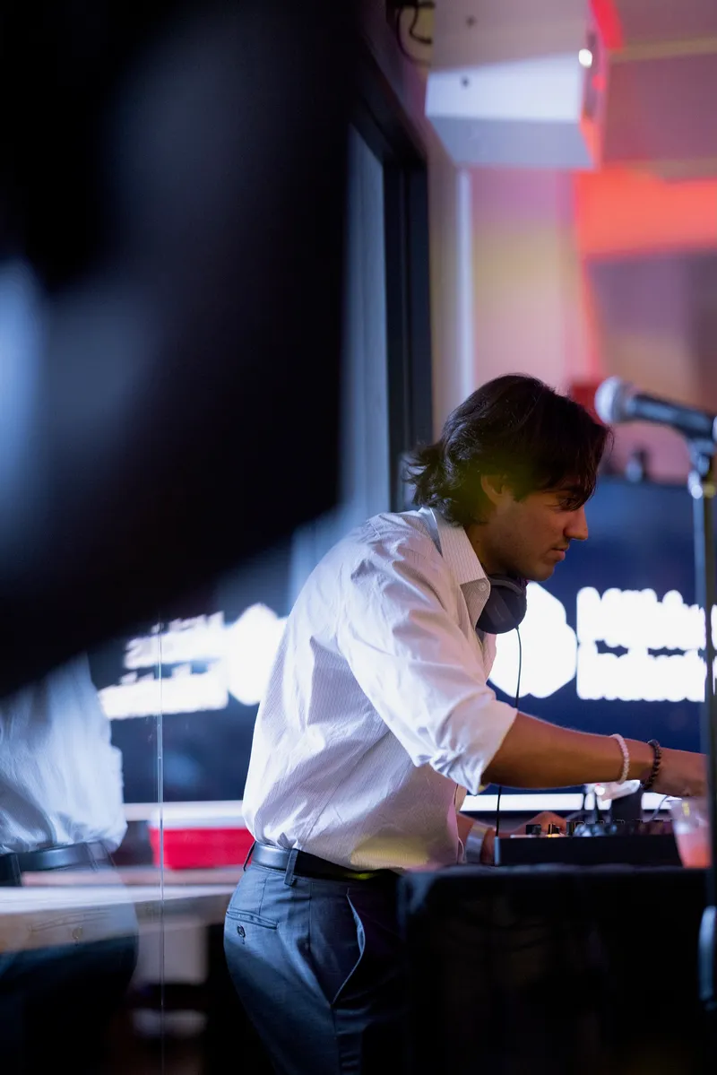 Close-up of Karl's hands on a DJ mixer at the Mobius Industries gala