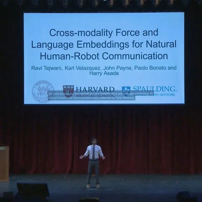 Karl presenting on stage at RSS 2025, title slide reading Cross-modality Force and Language Embeddings for Natural Human-Robot Communication